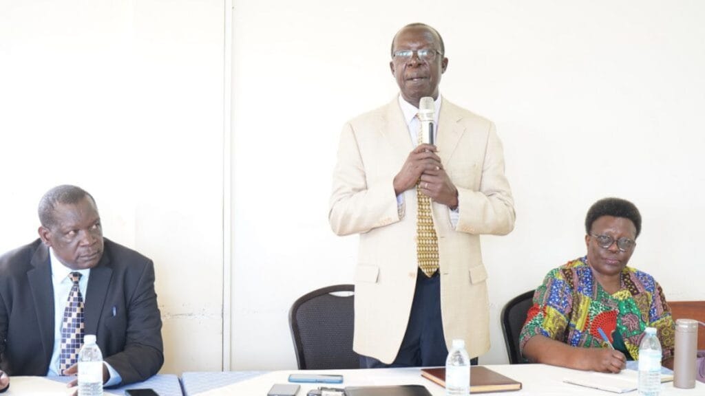Mr. David Geoffrey Opiokello, Chairperson Council speaking as Vice Chairperson Council, Ms. Nellie Florence Okullo(R) and CPA Nathan Hagobi(L) look on